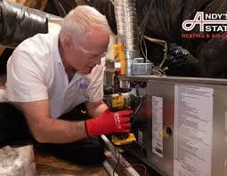 Service technician inspecting heating equipment controls